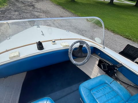 Boat helm and blue vinyl seating cleaned during a boat detail