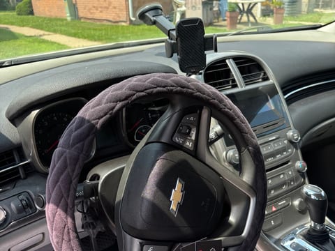 A TNL Detailing paper floor mat and business cards left in a finished Chevrolet interior