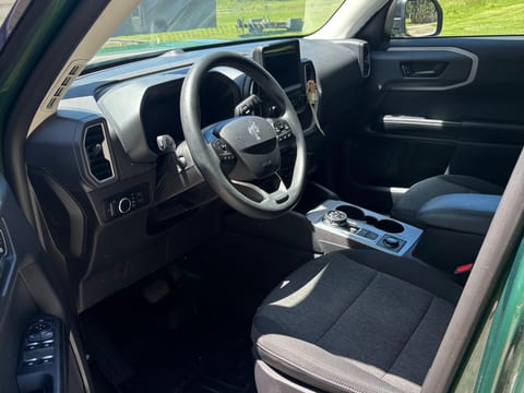 Ford Bronco Sport interior with the driver's door open after an interior detail