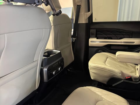 Tan leather seats and cleaned carpet in a Ford Expedition after an interior detail